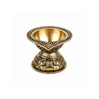 A brass diya is a traditional Indian oil lamp that symbolizes light.